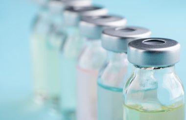 Macro view on vials. Different color of liquid medicine. Development of medications and vaccines.