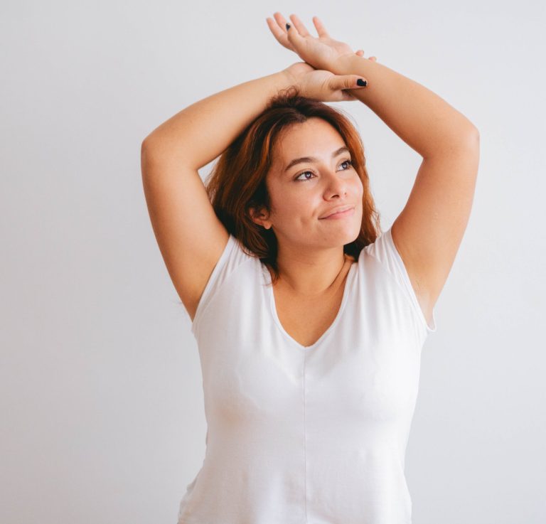 plus size curvy young latin woman with her arms up happy. copy space